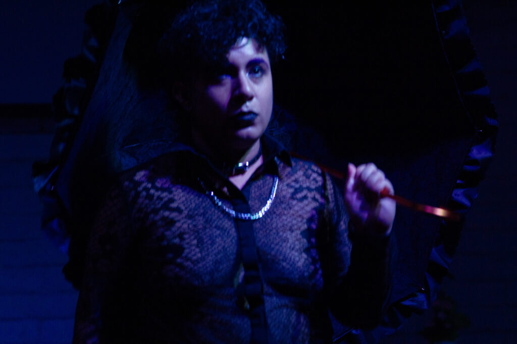 Me wearing a sheer shirt, holding a lacey parcel